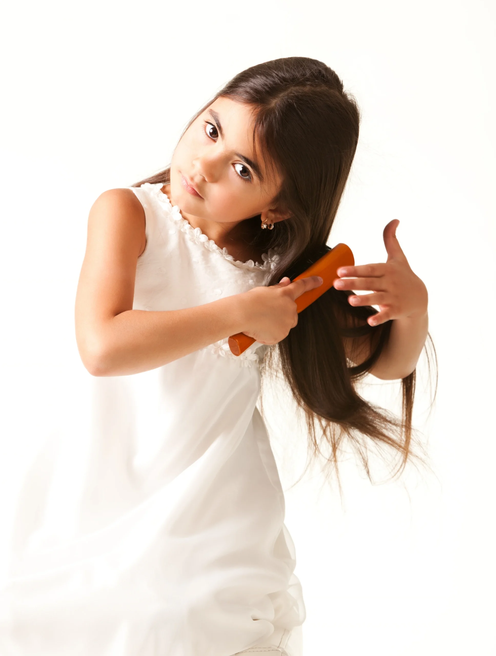 Weston girl in white dress combing brown hair scaled