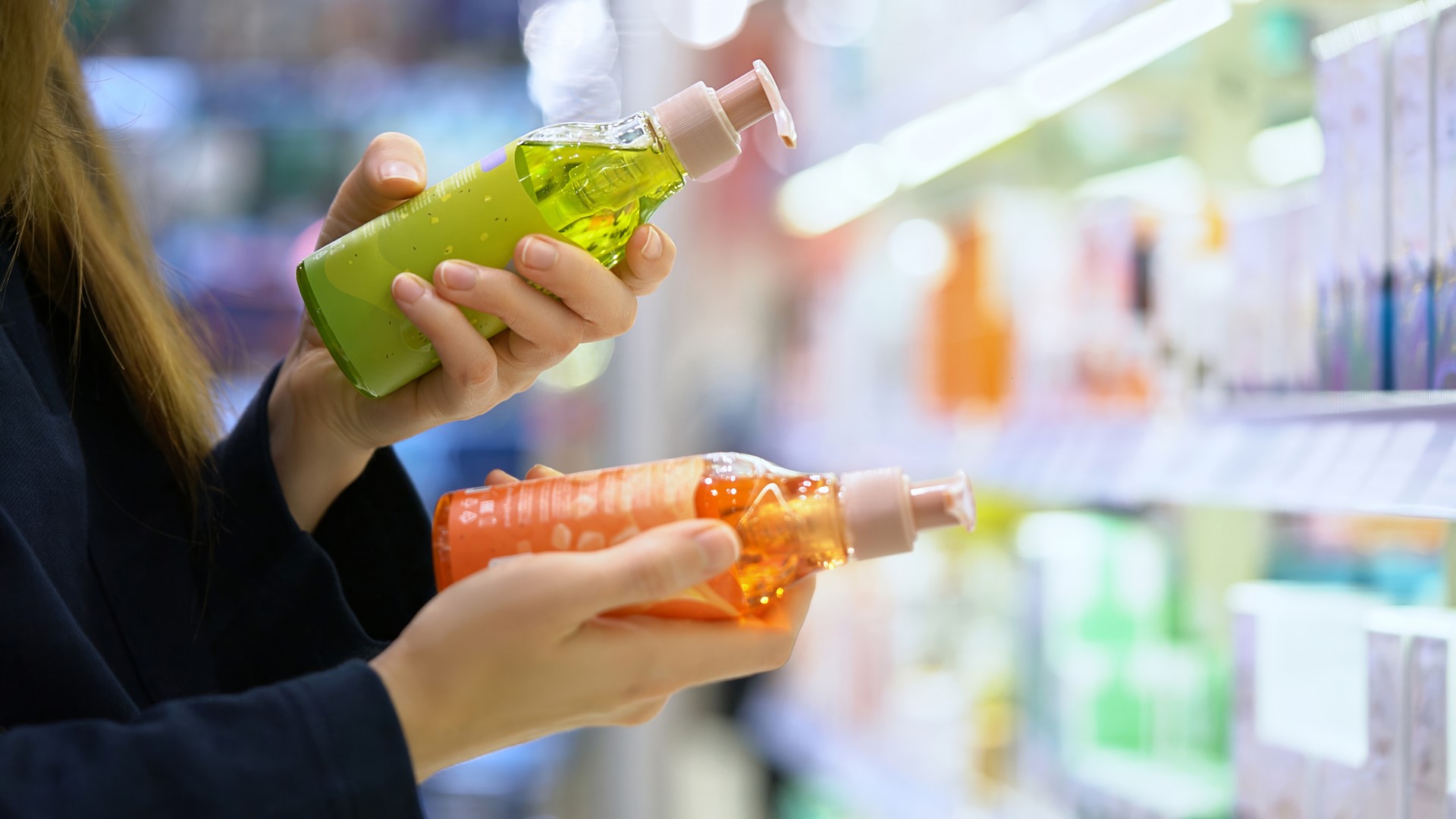 Parent comparing lice prevention product labels in a store aisle