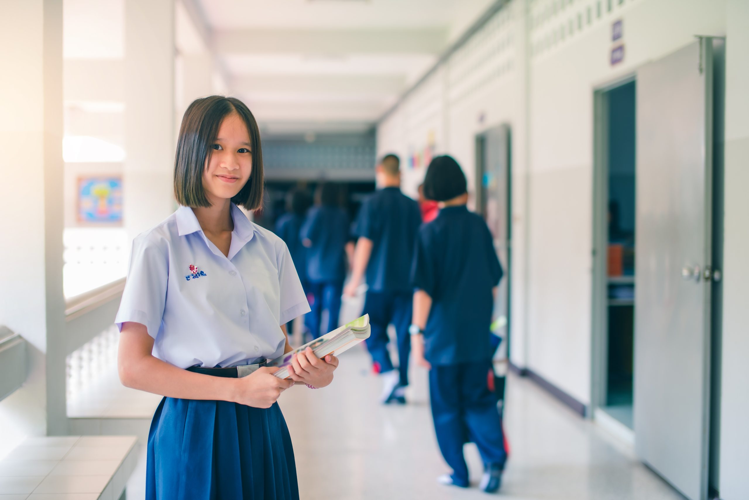 Student in school hallway for back to school lice prevention