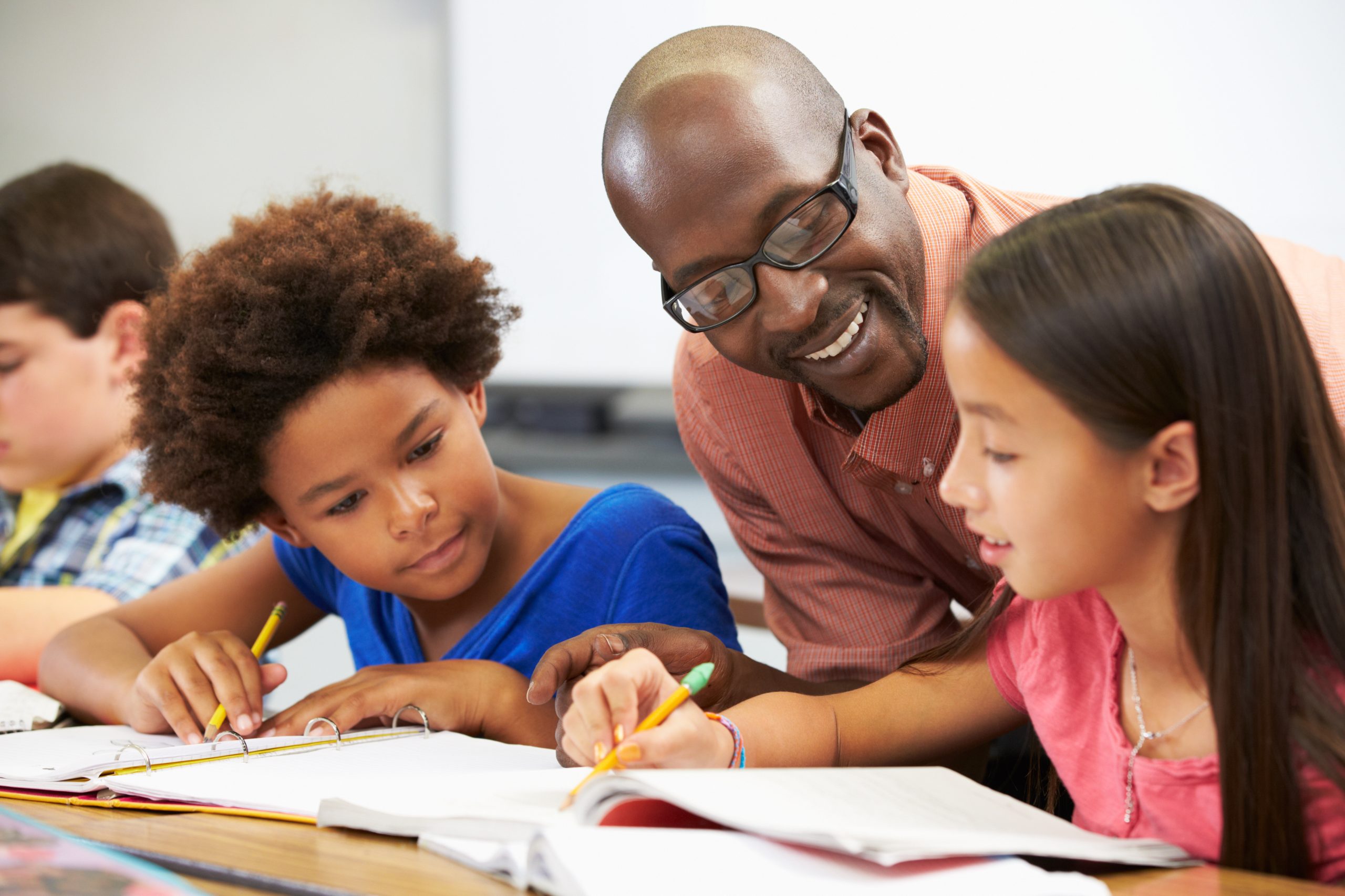 Teacher helping students in classroom for school and work lice guidance